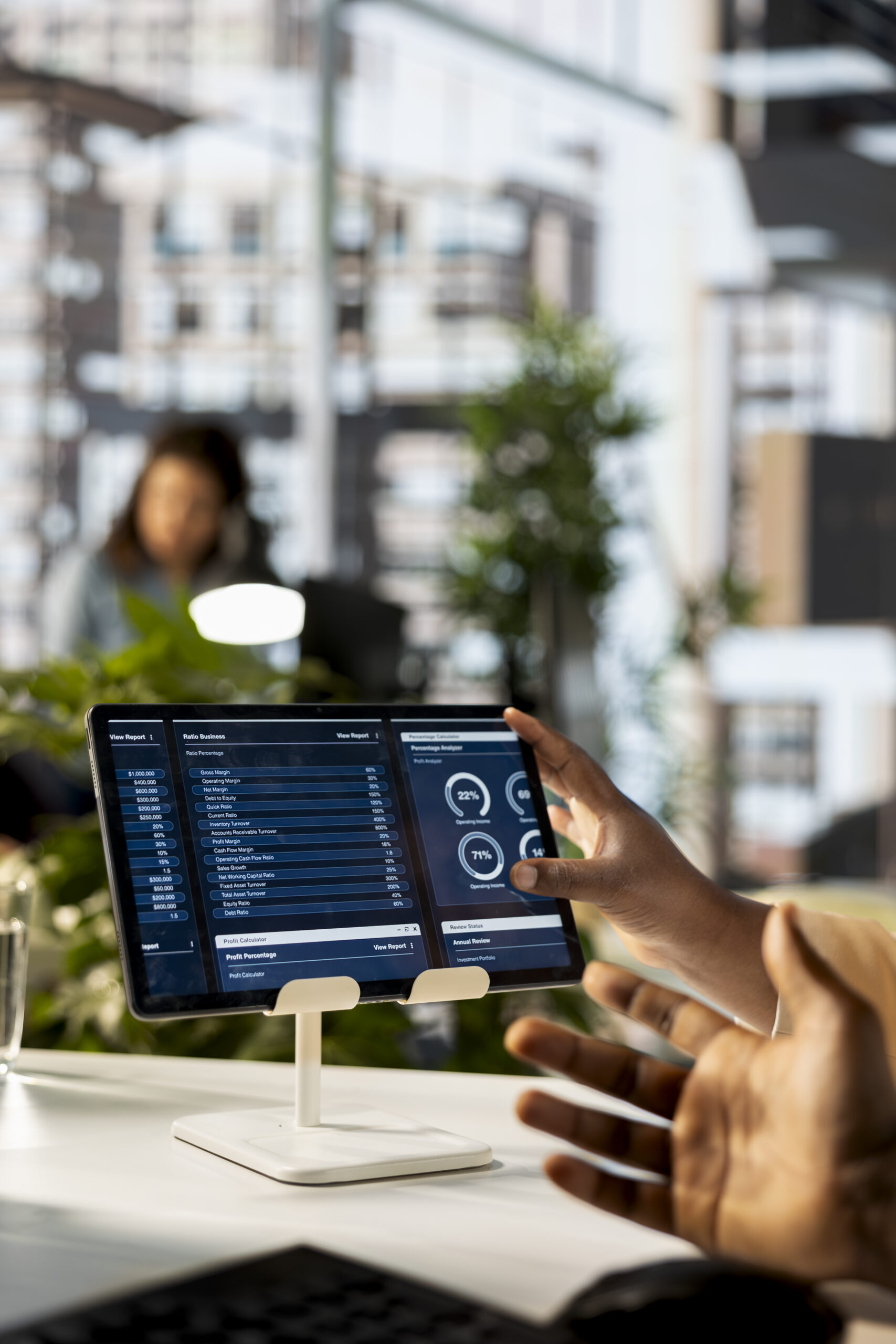 African American company employees handling financial planning in a corporate office, emphasizing teamwork to guarantee enterprise growth. Coworkers study online reports. Close up.