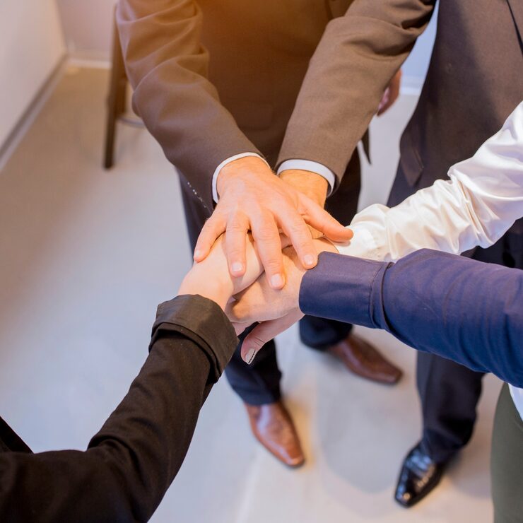 close-up-businesspeople-stacking-hands-meeting-office_23-2147923361
